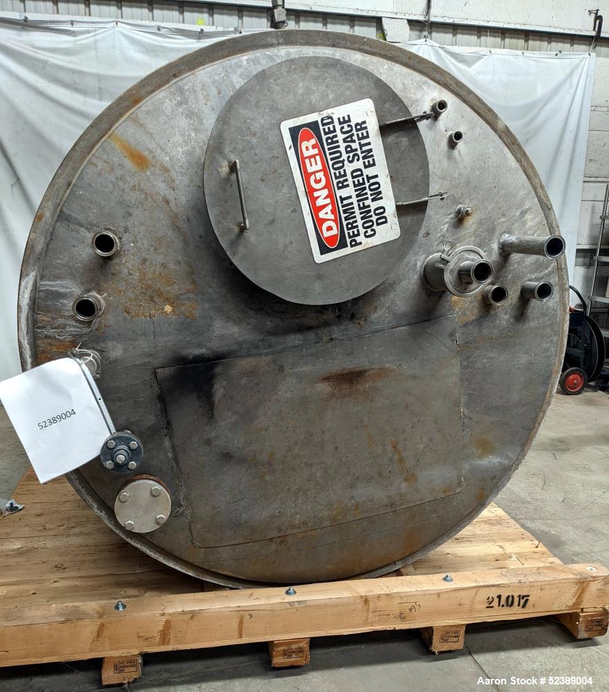 Used 1200 Gallon Stainless Steel Tank, Vertical. Approximate 66" diameter x 80" deep. Dished top & bottom heads. Openings top: 20" diameter manway with cover, (1) 4" tri-clamp reduced to 2", (1) 3" d...