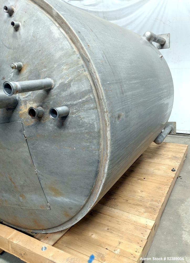 Used 1200 Gallon Stainless Steel Tank, Vertical. Approximate 66" diameter x 80" deep. Dished top & bottom heads. Openings top: 20" diameter manway with cover, (1) 4" tri-clamp reduced to 2", (1) 3" d...