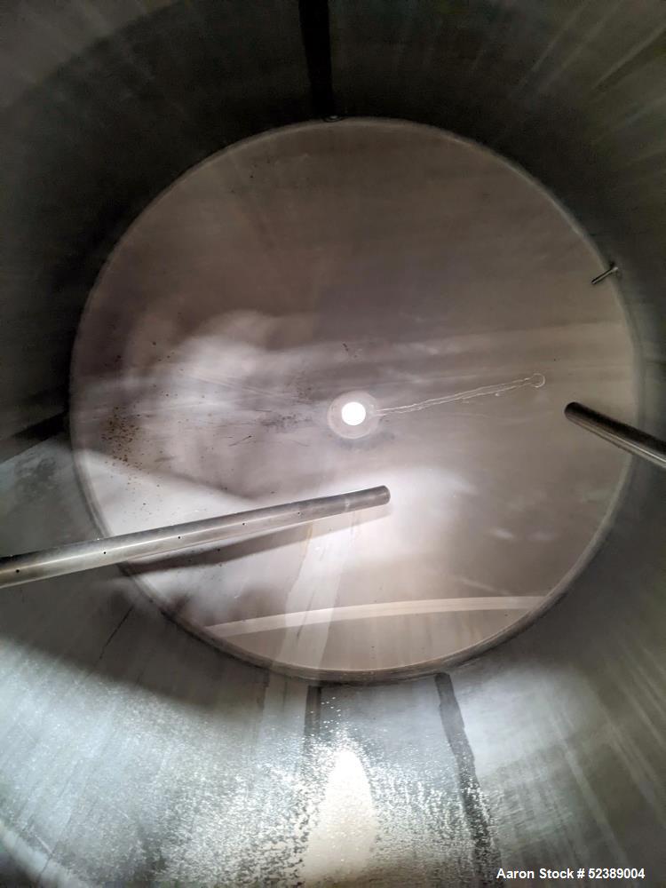 Used 1200 Gallon Stainless Steel Tank, Vertical. Approximate 66" diameter x 80" deep. Dished top & bottom heads. Openings top: 20" diameter manway with cover, (1) 4" tri-clamp reduced to 2", (1) 3" d...