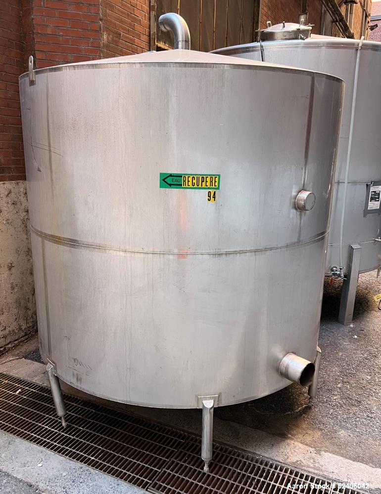 Used Tank, Approximate 1800 Gallon, Stainless Steel, Vertical. Approximate 84" diameter x 72" straight side, coned top & bottom. Mounted on 6 stainless legs.