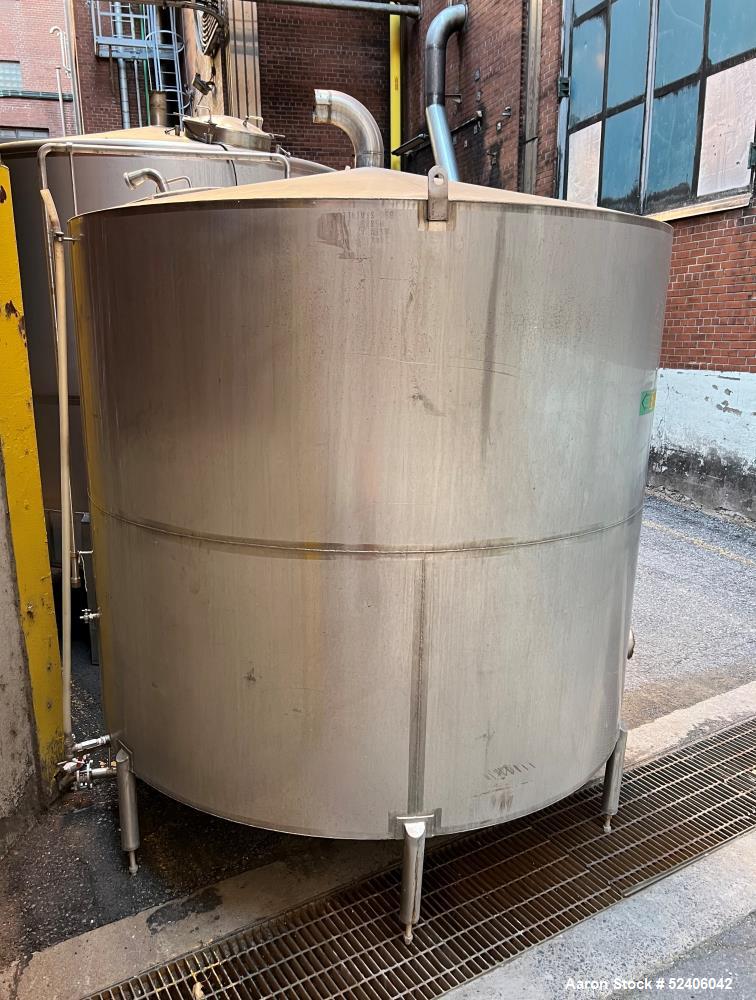 Used Tank, Approximate 1800 Gallon, Stainless Steel, Vertical. Approximate 84" diameter x 72" straight side, coned top & bottom. Mounted on 6 stainless legs.