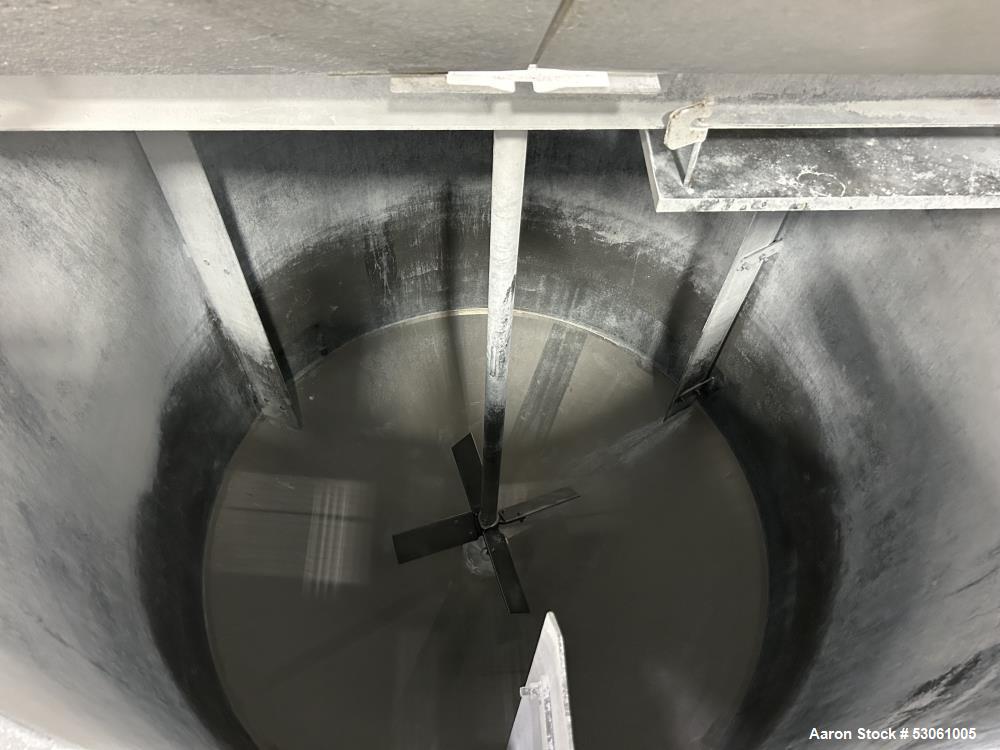 Used 1,000 Gallon Mix Tank, W/ agitation, approx. 2" shaft, 4 blade trubine, with 3 internal baffles. Flat top w/2 piece hinge cover. Cone bottom (approx 8"). 3" center bottom outlet w/reducing flang...