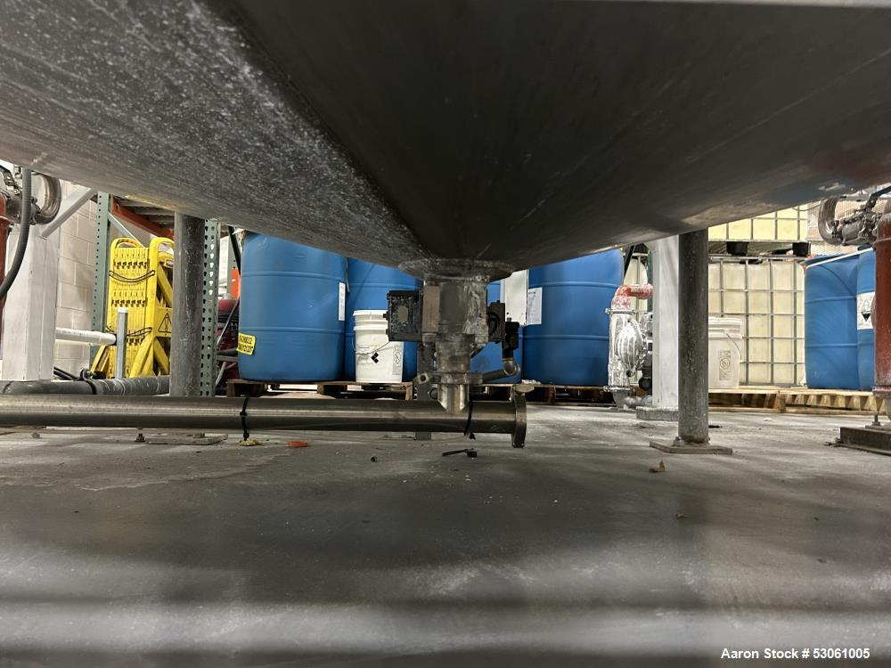 Used 1,000 Gallon Mix Tank, W/ agitation, approx. 2" shaft, 4 blade trubine, with 3 internal baffles. Flat top w/2 piece hinge cover. Cone bottom (approx 8"). 3" center bottom outlet w/reducing flang...
