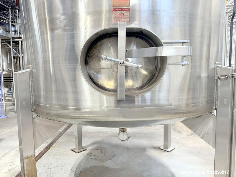 Used Stainless Steel Tank, Approximate 1,000 gallon. Center bottom outlet, side bottom manway, on (4) stainless steel legs.