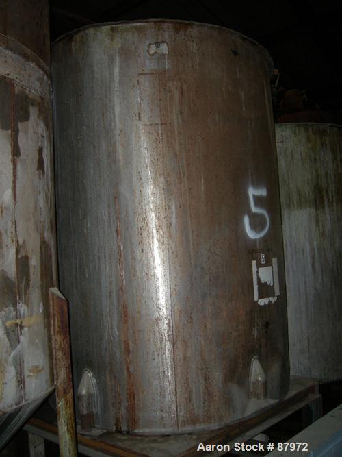 USED: Tank, 1,000 gallon, stainless steel. 60" diameter x 81" straight side. Open top, flat bottom. Approximate 2" diameter shaft with (2) 3 blade props. Mounted on 4 cut off carbon steel legs.