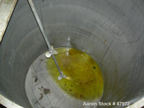 USED: Tank, 1,000 gallon, stainless steel. 60" diameter x 81" straight side. Open top, flat bottom. Approximate 2" diameter shaft with (2) 3 blade props. Mounted on 4 cut off carbon steel legs.