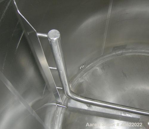 Used APV Crepaco Tank, 1500 Gallon, 304 Stainless Steel, Vertical. 84" diameter x 66" straight side. Dish top, sloped bottom. Fixed stainless steel agitator bridge with a 2" diameter bottom supported...