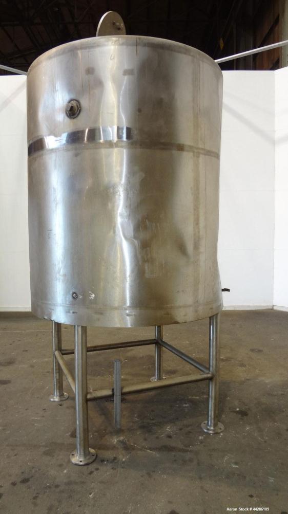 Used C.E. Howard Tank, 1000 Gallon, 304 Stainless Steel, Vertical. 66" Diameter x 73" straight side. Flat top, sloped bottom. Openings top 2”, 3”, 18” man way with cover. 2” Side bottom outlet. Mount...