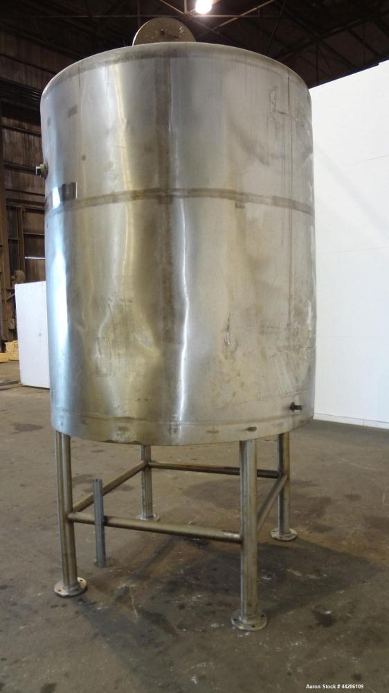 Used C.E. Howard Tank, 1000 Gallon, 304 Stainless Steel, Vertical. 66" Diameter x 73" straight side. Flat top, sloped bottom. Openings top 2”, 3”, 18” man way with cover. 2” Side bottom outlet. Mount...