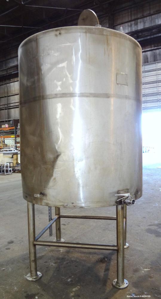 Used C.E. Howard Tank, 1000 Gallon, 304 Stainless Steel, Vertical. 66" Diameter x 73" straight side. Flat top, sloped bottom. Openings top 2”, 3”, 18” man way with cover. 2” Side bottom outlet. Mount...
