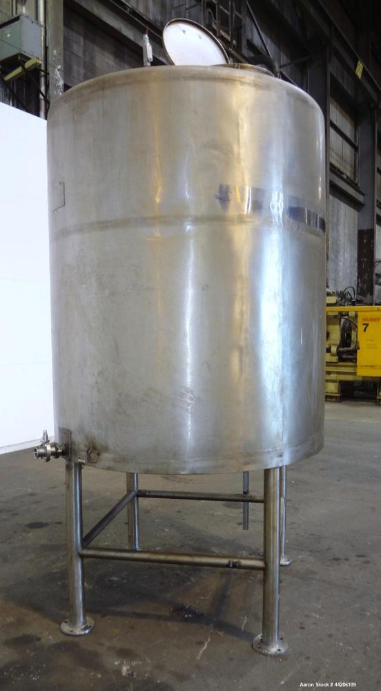 Used C.E. Howard Tank, 1000 Gallon, 304 Stainless Steel, Vertical. 66" Diameter x 73" straight side. Flat top, sloped bottom. Openings top 2”, 3”, 18” man way with cover. 2” Side bottom outlet. Mount...