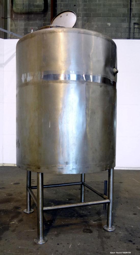 Used C.E. Howard Tank, 1000 Gallon, 304 Stainless Steel, Vertical. 66" Diameter x 73" straight side. Flat top, sloped bottom. Openings top 2”, 3”, 18” man way with cover. 2” Side bottom outlet. Mount...