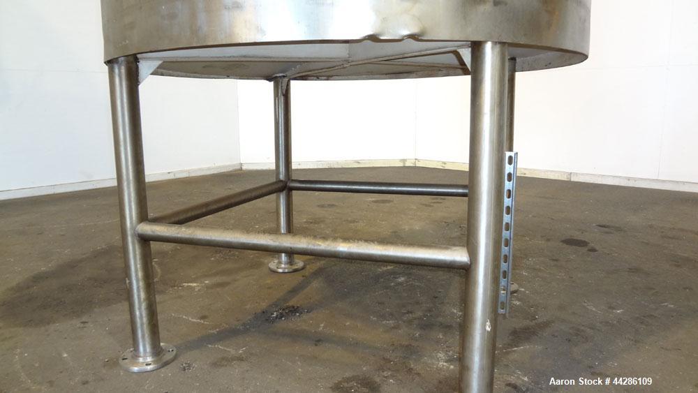 Used C.E. Howard Tank, 1000 Gallon, 304 Stainless Steel, Vertical. 66" Diameter x 73" straight side. Flat top, sloped bottom. Openings top 2”, 3”, 18” man way with cover. 2” Side bottom outlet. Mount...
