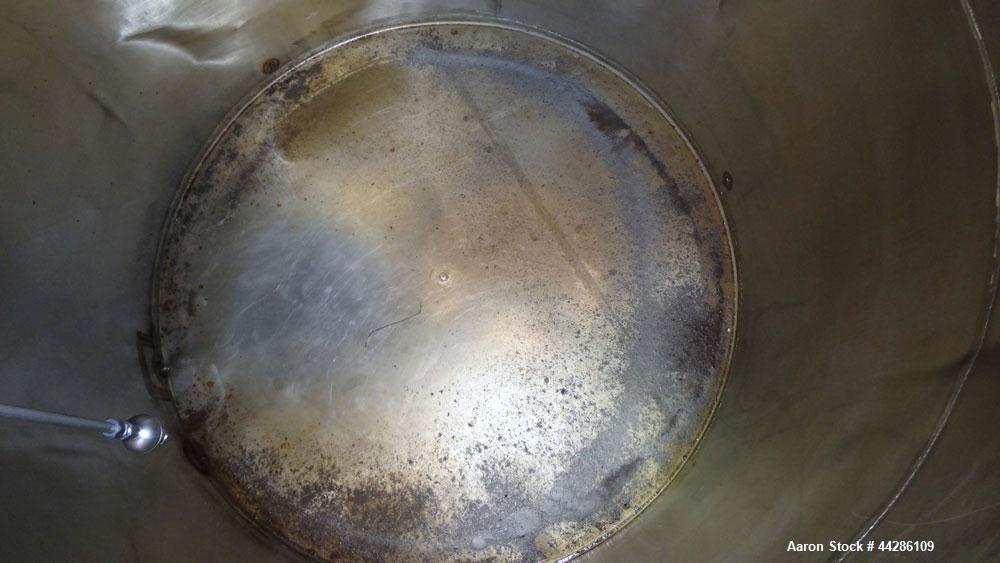 Used C.E. Howard Tank, 1000 Gallon, 304 Stainless Steel, Vertical. 66" Diameter x 73" straight side. Flat top, sloped bottom. Openings top 2”, 3”, 18” man way with cover. 2” Side bottom outlet. Mount...