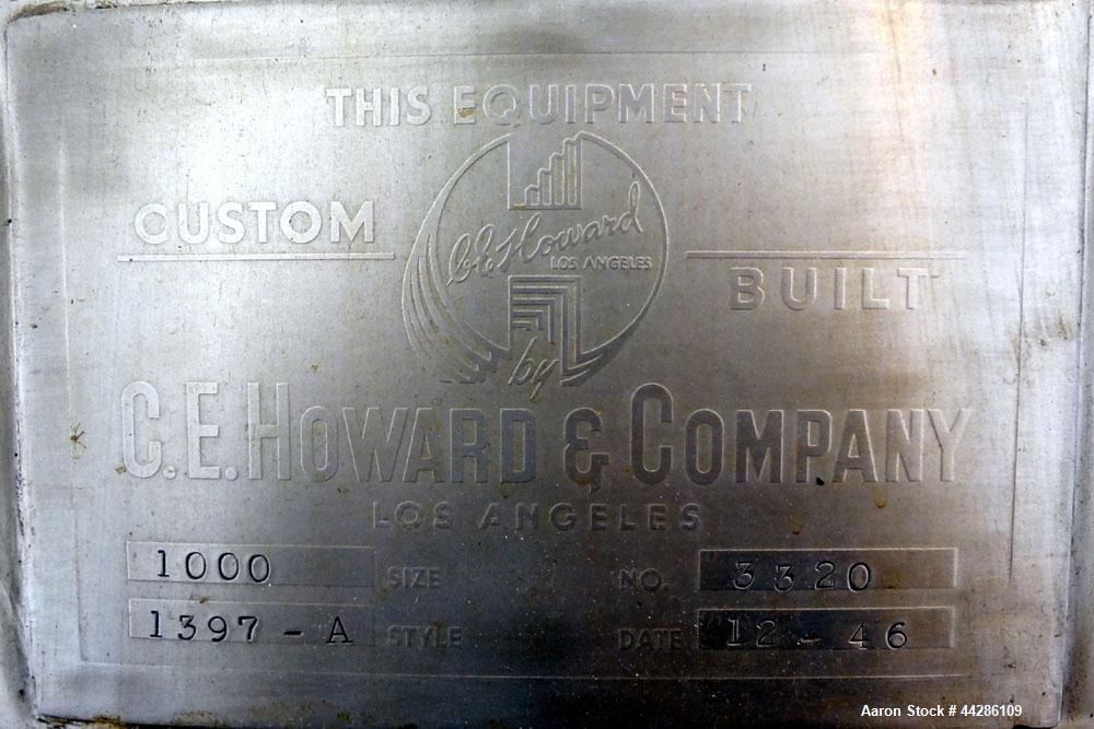 Used C.E. Howard Tank, 1000 Gallon, 304 Stainless Steel, Vertical. 66" Diameter x 73" straight side. Flat top, sloped bottom. Openings top 2”, 3”, 18” man way with cover. 2” Side bottom outlet. Mount...