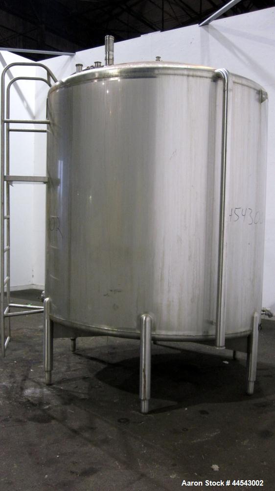 Used Cherry Burrell Tank, 2000 Gallon, 304 Stainless Steel, Vertical. 84” Diameter x 81” straight side, dished top, sloped bottom. (1) Spray ball, external side ladder. Openings: top (2) 2”, 3”, 3" v...