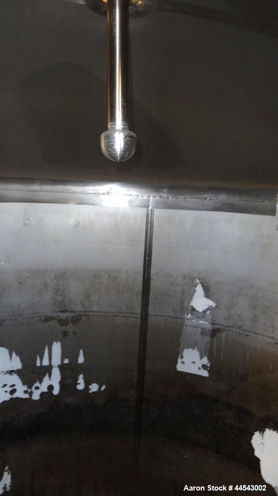 Used Cherry Burrell Tank, 2000 Gallon, 304 Stainless Steel, Vertical. 84” Diameter x 81” straight side, dished top, sloped bottom. (1) Spray ball, external side ladder. Openings: top (2) 2”, 3”, 3" v...