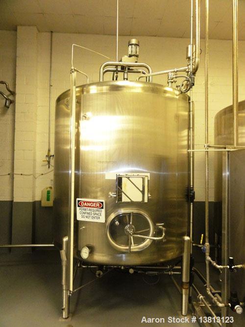 Used Cherry Burrell 2,000 Gallon Top Agitated Mixing Tank, Model CV.  304 Stainless steel mixing tank with (4) stainless steel legs.  Approximately 7' diameter x 6'6" straight wall x 13' overall heig...