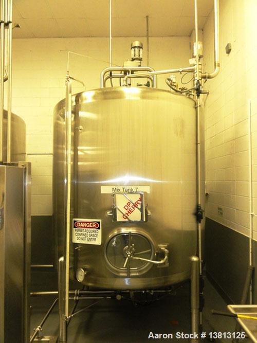 Used Cherry Burrell 2,000 Gallon Top Agitated Mixing Tank, Model CV.  304 Stainless steel mixing tank with (4) stainless steel legs.  Approximately 7' diameter x 6'6" straight wall x 13' overall heig...