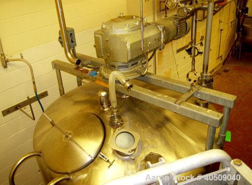 Used Creamery Package Tank, 1000 Gallon, stainless steel, vertical. 72" diameter x 54" straight side. Dished top, coned bottom. Fixed carbon steel agitator bridge, bottom supported anchor agitator wi...