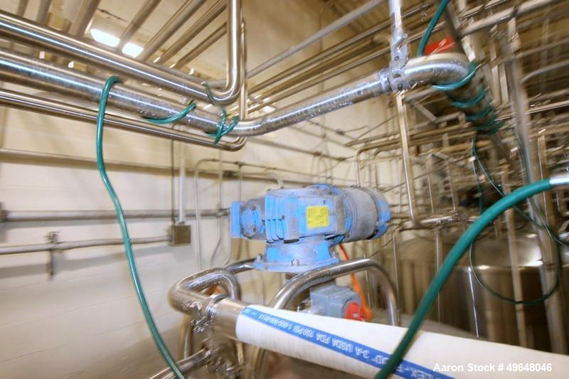 Used DCI 2,000 Gallon Stainless Steel Single Wall Mix Tank, Vertical. Dome Top/Cone Bottom. Top mounted agitation with bottom sweep blade and motor. Top entering baffle. Dual CIP Spray Ball. Mounted ...