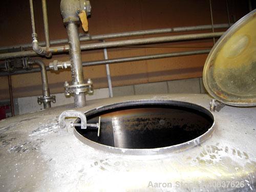 Used Ertel Tank, 2000 gallon, stainless steel, vertical. Approximately 80" diameter x 96" straight side. Slight dished top and bottom. Openings top (3)2", 17" manway, bottom 2", 4" center. Mounted on...