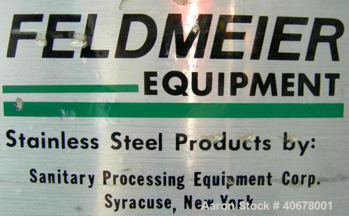 Used Feldmeier Tank, 1900 gallon, 316 stainless steel, vertical. 80" diameter x 84" straight side, coned top and bottom. Openings: top 4", 2" tri-clamp, 20" manway with cover; 3" tri-clamp tangential...