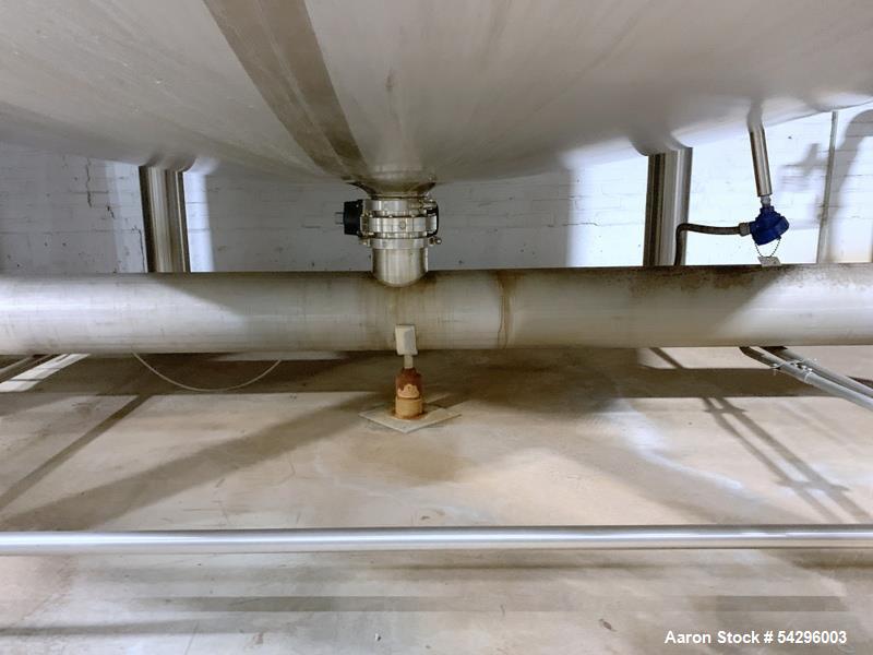 Used Feldmeier Stainless Steel Tank, Approximate 4,700 gallon. Vertical, slight dished top and bottom, center bottom outlet, on (4) stinless steel legs.
