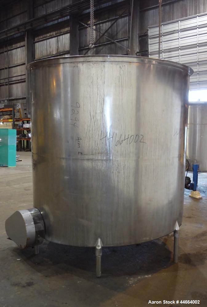 Used Filpaco Tank, 2000 Gallons, 304 Stainless Steel, Vertical. Approximate 86” Diameter X 81” straight side, open top with (2) covers, sloped bottom. Side bottom entering agitator with a (3) blade p...