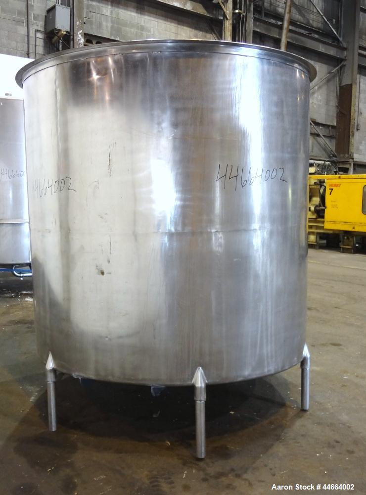 Used Filpaco Tank, 2000 Gallons, 304 Stainless Steel, Vertical. Approximate 86” Diameter X 81” straight side, open top with (2) covers, sloped bottom. Side bottom entering agitator with a (3) blade p...