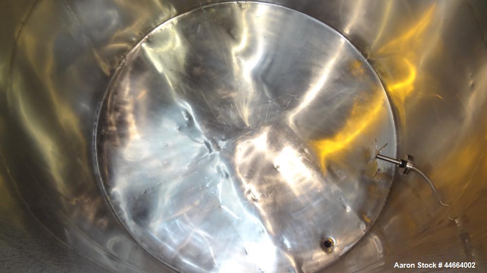 Used Filpaco Tank, 2000 Gallons, 304 Stainless Steel, Vertical. Approximate 86” Diameter X 81” straight side, open top with (2) covers, sloped bottom. Side bottom entering agitator with a (3) blade p...