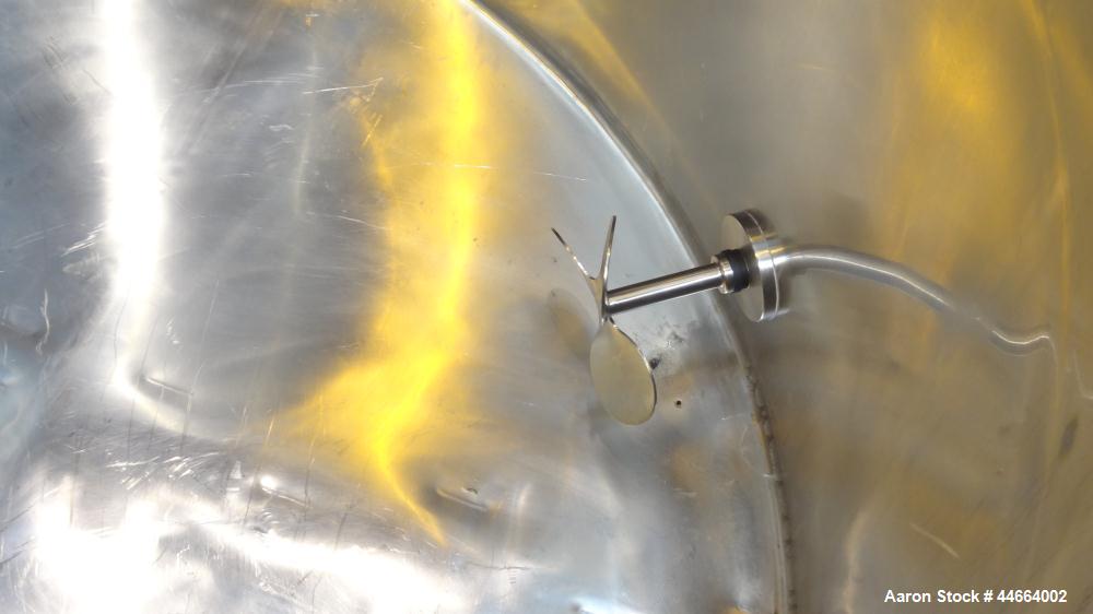 Used Filpaco Tank, 2000 Gallons, 304 Stainless Steel, Vertical. Approximate 86” Diameter X 81” straight side, open top with (2) covers, sloped bottom. Side bottom entering agitator with a (3) blade p...