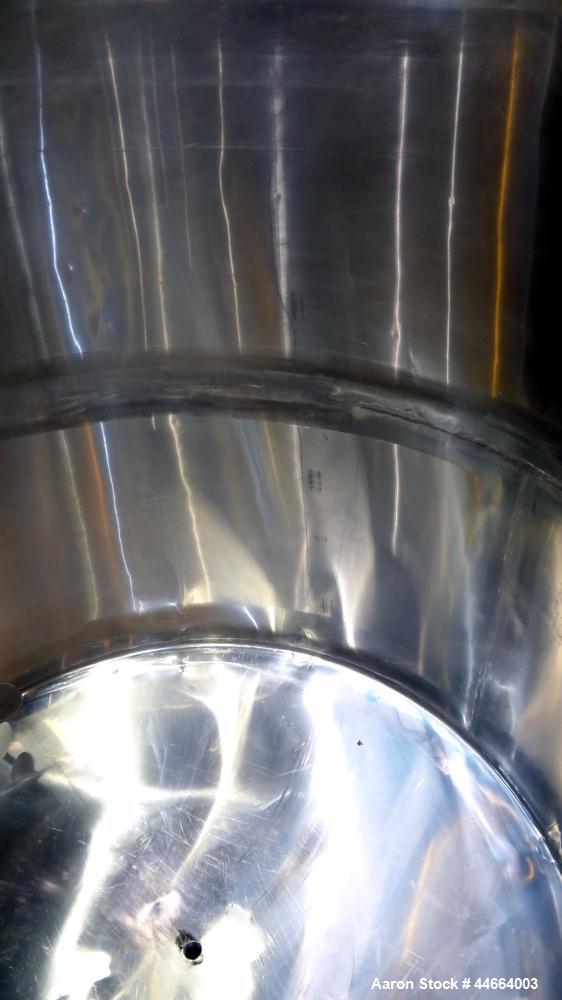 Used Filpaco Tank, 2000 Gallons, 304 Stainless Steel, Vertical. 86” Diameter X 84” straight side, open top with (2) covers, cone bottom. Side bottom entering agitator with a (3) blade prop driven by ...