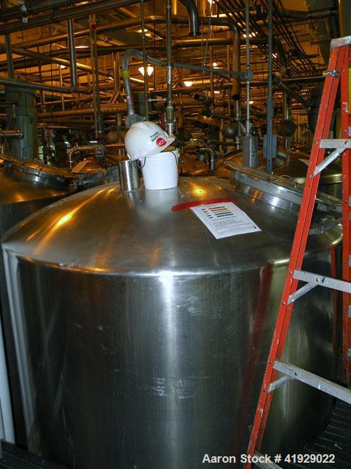 Used Lee Metal Products Tank, 2000 Gallon, Stainless Steel, Vertical. 76" diameter x 106" straight side, dished top and bottom. Openings top (2) 3" tri-clamp, 4" vent, (2) 20" manway with cover, side...
