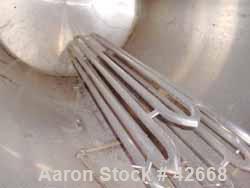 Used Mojonnier Tank, 1500 Gallon, Stainless Steel, Horizontal. Approximately 72" diameter x 101" straight side, dished ends. Insulated, carbon steel shell. End bottom bayonette style pipe heater. Ope...