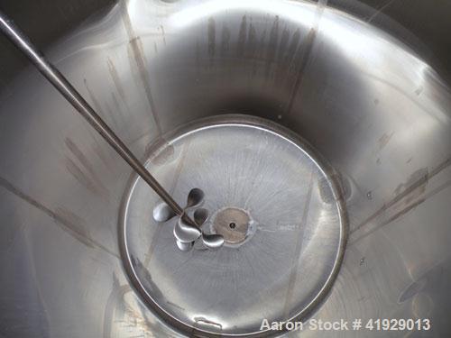 Used Mueller Tank, 2000 Gallon, Model F, Stainless Steel, Vertical. 76" diameter x 106" straight side, dished top and bottom. Off center top entering angled Lightnin manual variable speed agitator, m...