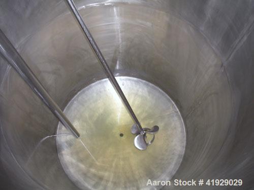 Used Mueller Tank, 2000 Gallon, Model F, 316 Stainless Steel, Vertical. 76" diameter x 106" straight side, dished top and bottom. Off center top entering angled Lightnin manual variable speed agitato...