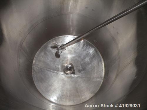 Used Mueller Tank, 2000 Gallon, Model F, Stainless Steel, Vertical. 76" diameter x 106" straight side, dished top and bottom. Off center top entering angled Lightnin manual variable speed agitator, m...