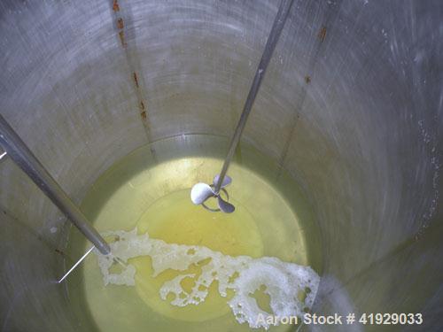 Used Mueller Tank, 2000 Gallon, Model F, stainless steel, vertical. 76" diameter x 106" straight side, dished top and bottom. Off center top entering angled Lightnin agitator, model N33G-300. 1-1/2" ...