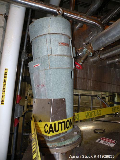 Used Mueller Tank, 2000 Gallon, Model F, stainless steel, vertical. 76" diameter x 106" straight side, dished top and bottom. Off center top entering angled Lightnin agitator, model N33G-300. 1-1/2" ...