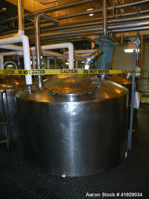 Used Mueller Tank, 2000 Gallon, Model F, stainless steel, vertical. 76" diameter x 106" straight side, dished top and bottom. Off center top entering angled Lightnin agitator, model N33G-300. Driven ...