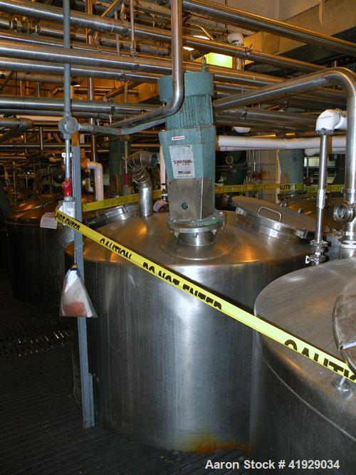 Used Mueller Tank, 2000 Gallon, Model F, stainless steel, vertical. 76" diameter x 106" straight side, dished top and bottom. Off center top entering angled Lightnin agitator, model N33G-300. Driven ...