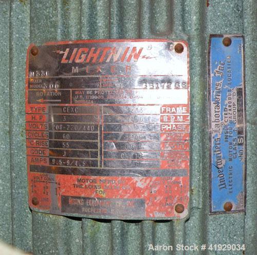 Used Mueller Tank, 2000 Gallon, Model F, stainless steel, vertical. 76" diameter x 106" straight side, dished top and bottom. Off center top entering angled Lightnin agitator, model N33G-300. Driven ...