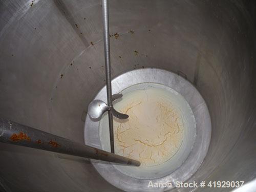 Used Mueller Tank, 2000 Gallon, Model F, stainless steel, vertical. 76" diameter x 106" straight side, dished top and bottom. Off center top entering angled Lightnin manual variable speed agitator, m...