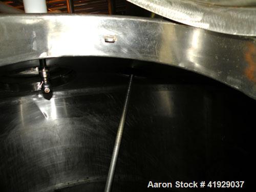 Used Mueller Tank, 2000 Gallon, Model F, stainless steel, vertical. 76" diameter x 106" straight side, dished top and bottom. Off center top entering angled Lightnin manual variable speed agitator, m...