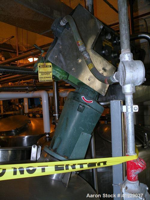 Used Mueller Tank, 2000 Gallon, Model F, stainless steel, vertical. 76" diameter x 106" straight side, dished top and bottom. Off center top entering angled Lightnin manual variable speed agitator, m...