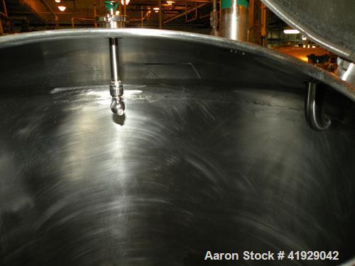 Used Mueller Tank, 2000 Gallon, Stainless Steel, Vertical. 76" diameter x 106" straight side, dished top and bottom. Openings top 3" tri-clamp, 4" tri-clamp, 4" vent, 8" drive (capped), 24" manway wi...