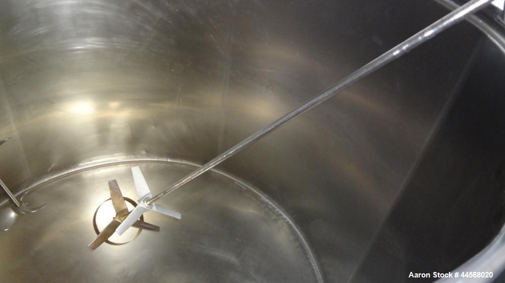 Used Mueller Tank, 1000 Gallons, 316 Stainless Steel, Vertical.  Approximately 76" diameter x 57" straight side, open top with (2) covers, sloped bottom.  (2) Lightnin clamp-on agitators.  (1) Model ...