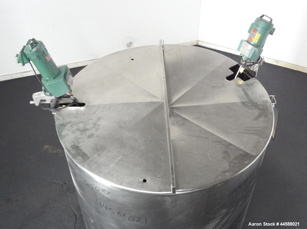 Used Mueller Tank, 1000 Gallon, 316 Stainless Steel, Vertical. Approximate 76” diameter x 57” straight side, open top with (2) covers, sloped bottom. (2) Lightnin clamp on agitators. (1) Model XJ-65V...