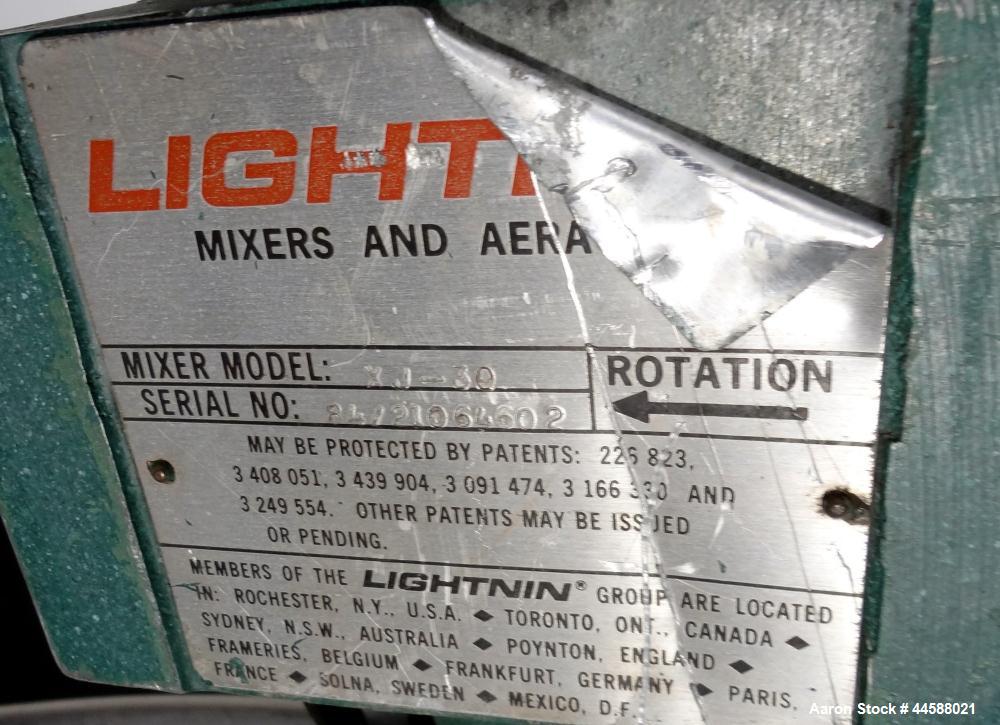 Used Mueller Tank, 1000 Gallon, 316 Stainless Steel, Vertical. Approximate 76” diameter x 57” straight side, open top with (2) covers, sloped bottom. (2) Lightnin clamp on agitators. (1) Model XJ-65V...